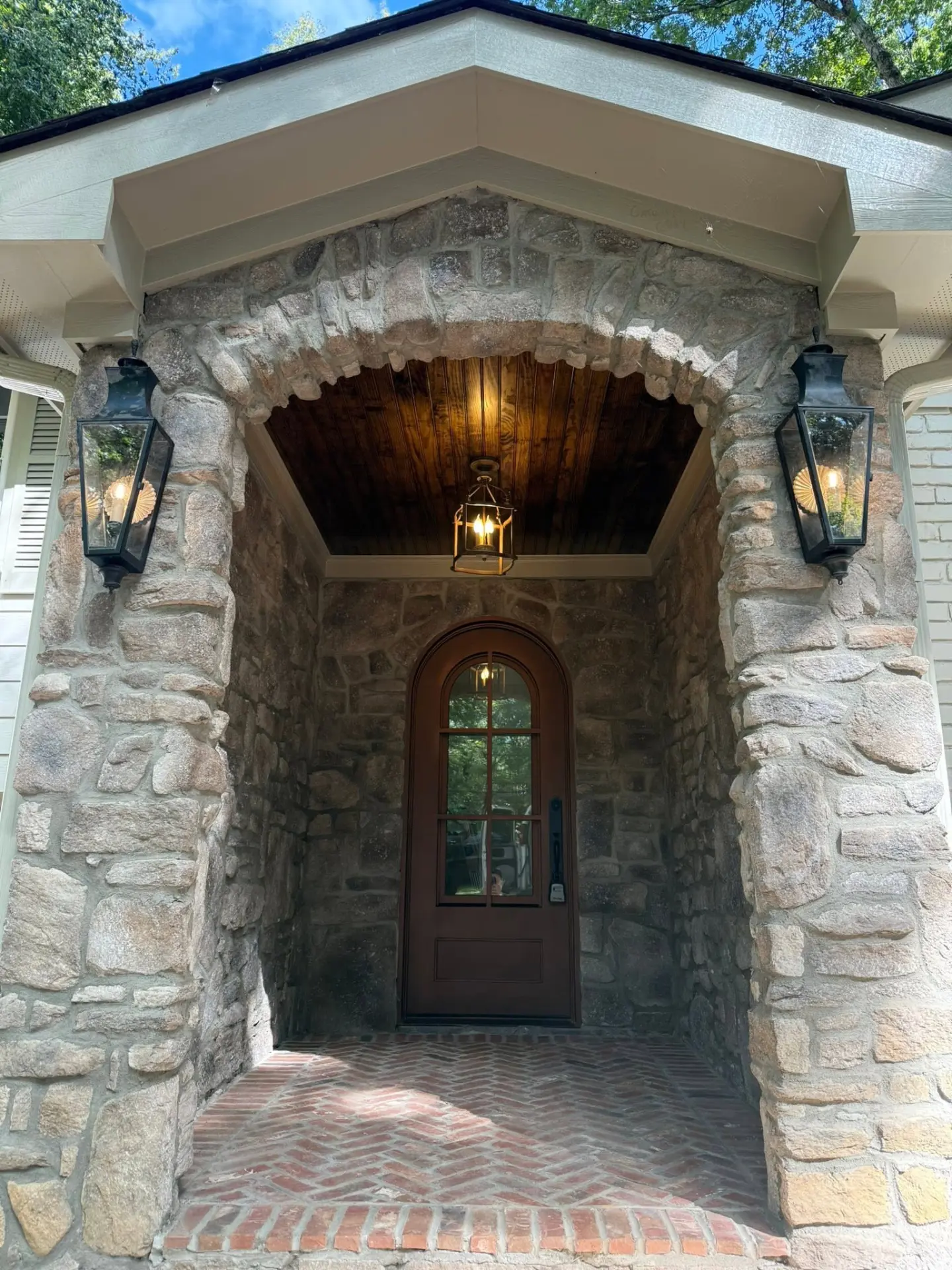 Stone arched entry with gas lanterns