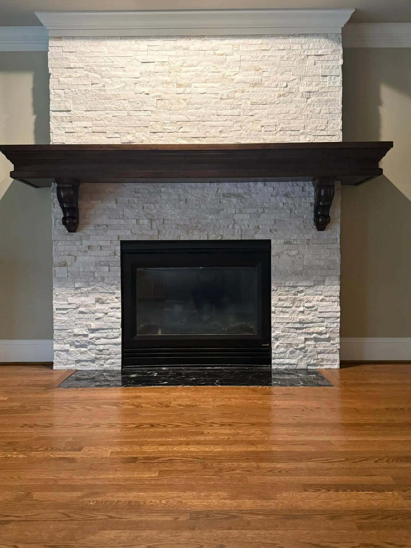 Stacked stone fireplace and mantel