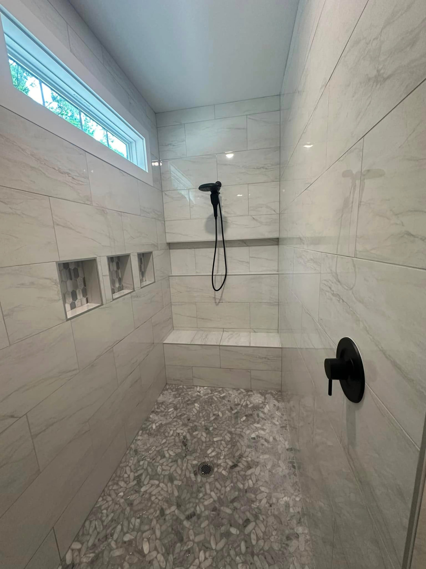 Tiled walk-in shower with bench